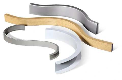 Curved aluminum profiles with sweeping bends in silver, white and wood-grain finishes