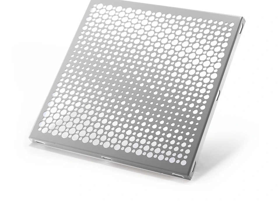 Decorative aluminum panel with a repeating pattern of large and small circular perforations