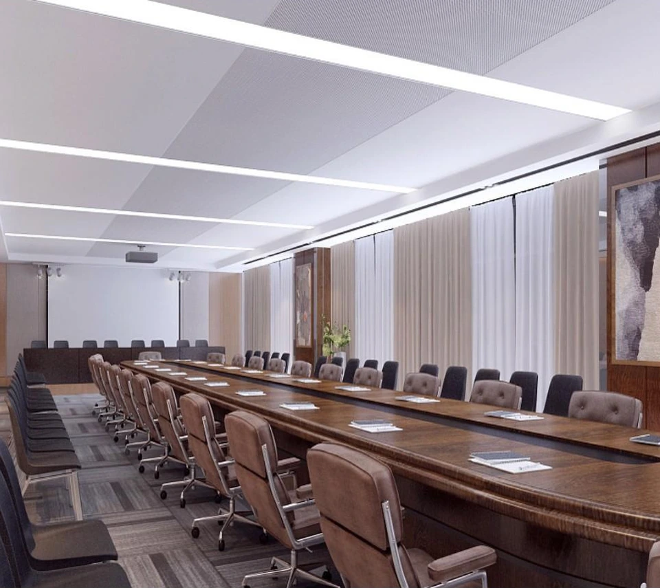 Large aluminum ceiling panels coordinated with linear lighting above a meeting room