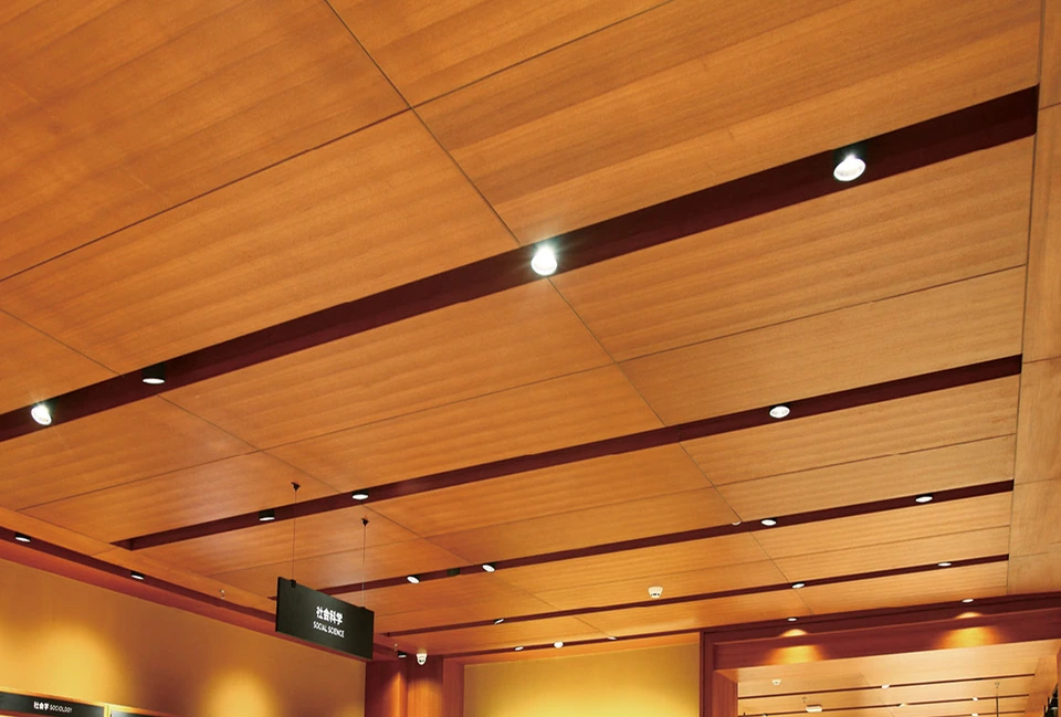 Wood-finished ceiling with aligned grain and recessed lighting channels