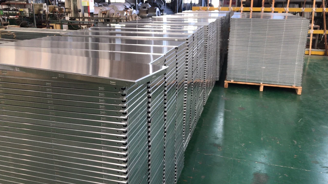 Stacks of formed aluminum panels with folded returns and fixing slots