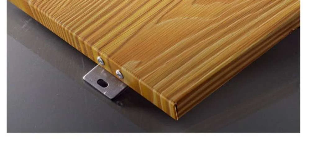 Wood-grain finish on a formed aluminum panel corner with a fixing bracket