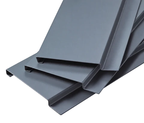 Stacked G-shaped aluminum ceiling strips showing flat faces and folded edge profiles