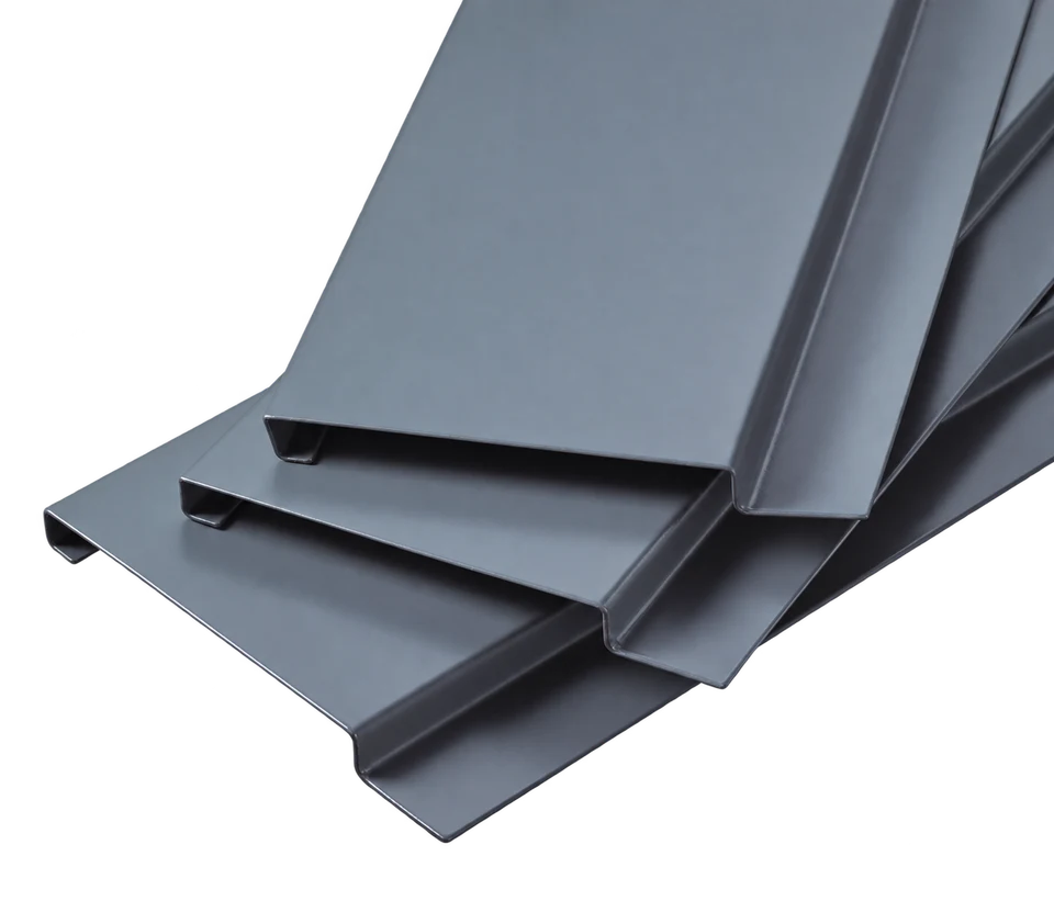 Stacked G-shaped aluminum ceiling strips showing flat faces and folded edge profiles