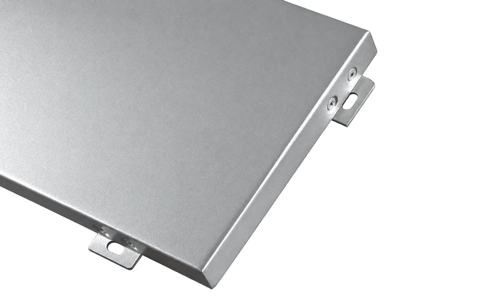 Open-joint aluminum cladding panel showing its silver face, folded perimeter and fixing tabs