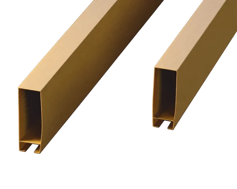 Gold-colored rectangular aluminum ceiling baffles showing hollow profile ends