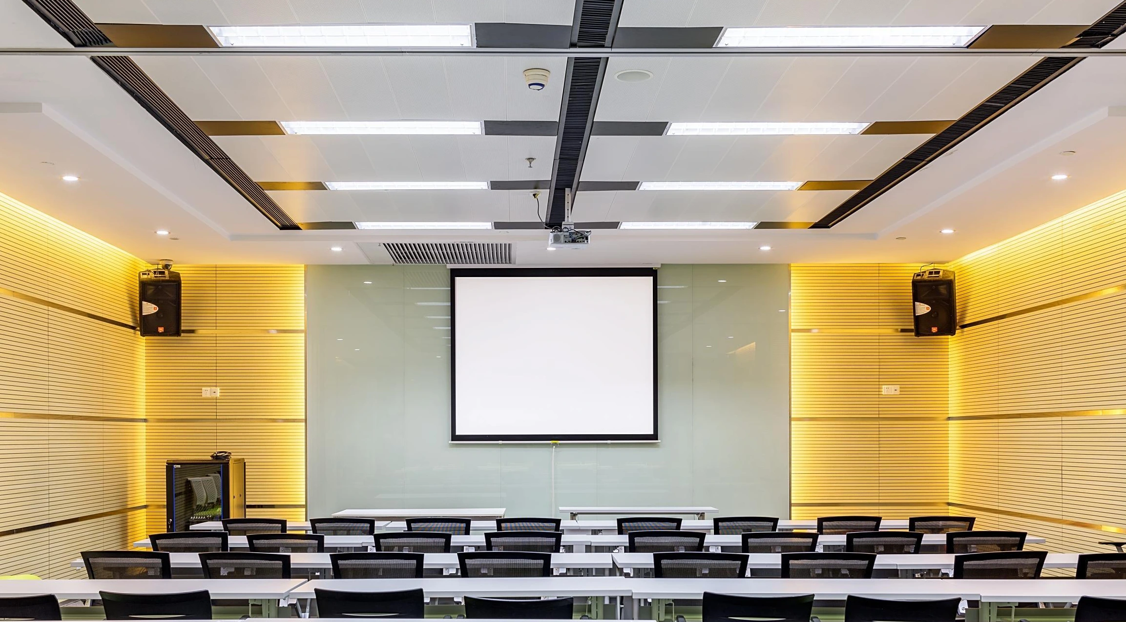 Strip ceiling panels and rectangular lighting above a university meeting room in Shenyang