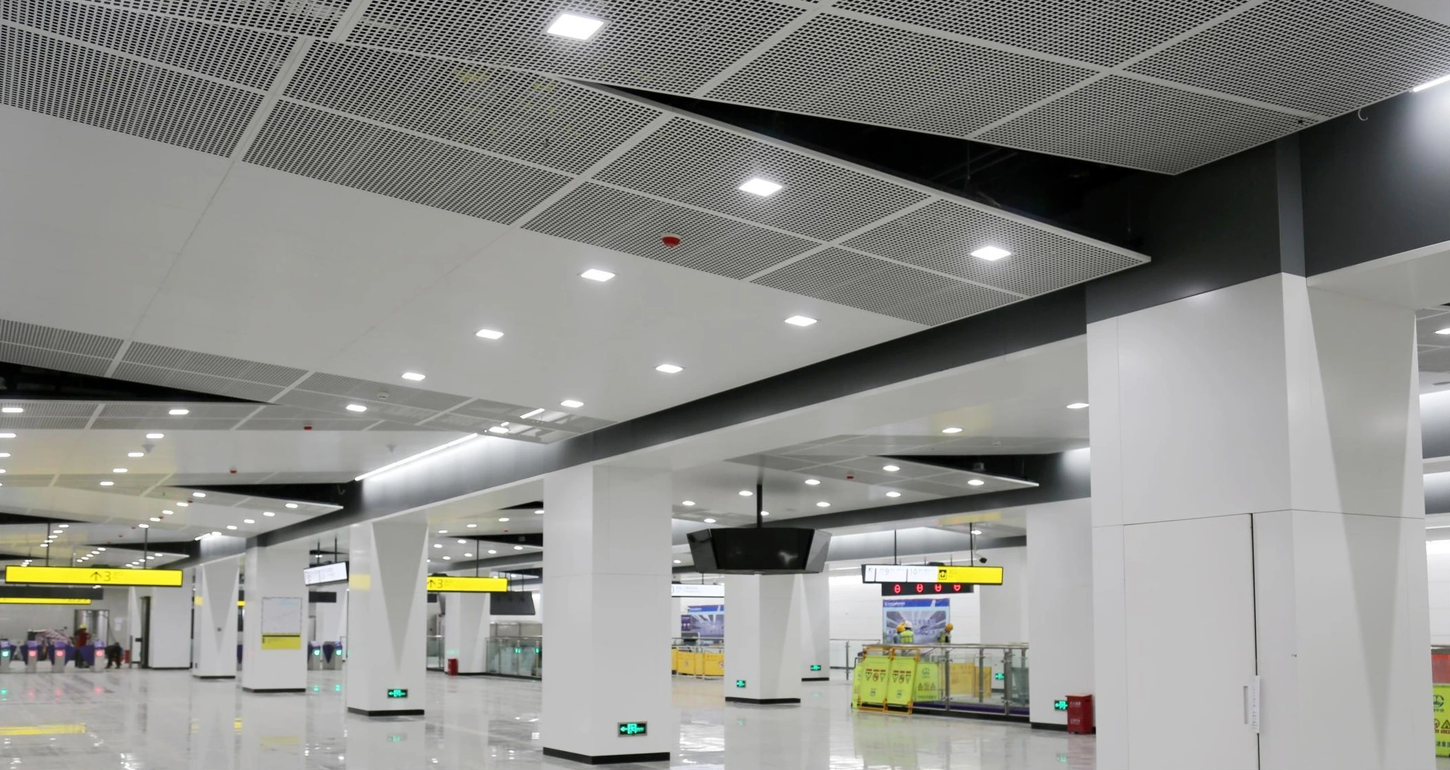 Perforated aluminum ceiling modules and column covers in a Chongqing metro station