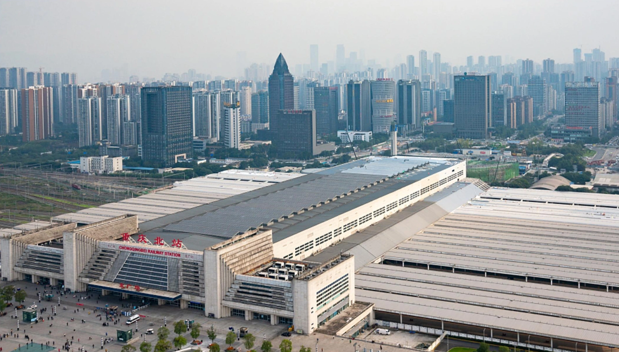 Elevated view of a Chongqing railway station showing the broad roof and entrance facade