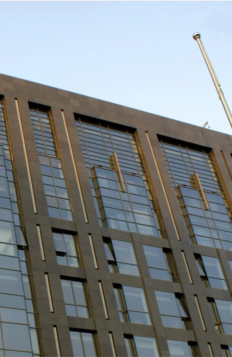 Vertical metal facade fins around glazed bays on a research and development office building
