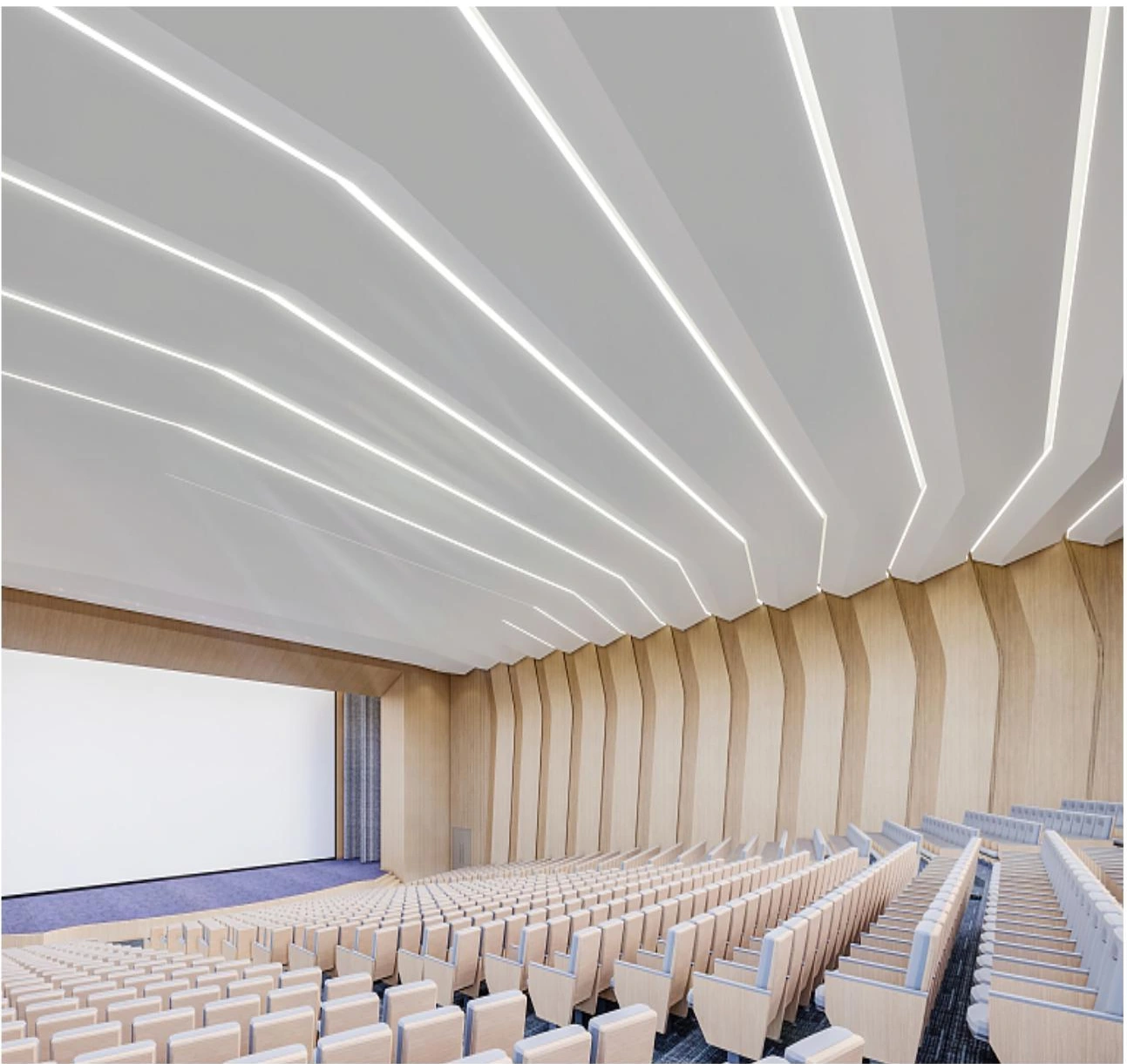 Fan-pattern aluminum ceiling panels and linear lights above school auditorium seating in Guangzhou
