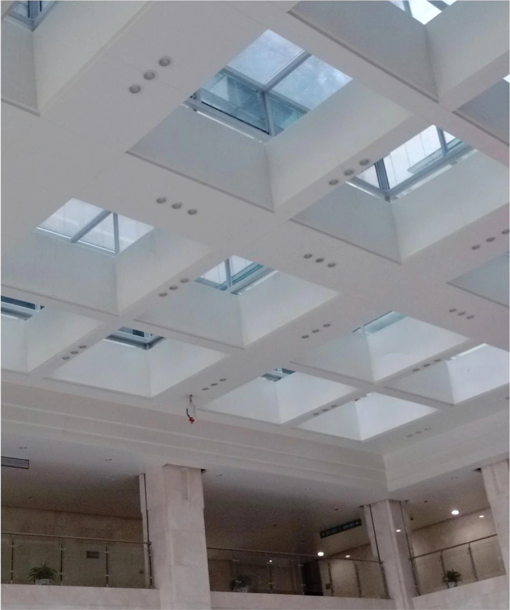 Recessed square skylights and white ceiling panels in a Huainan office interior