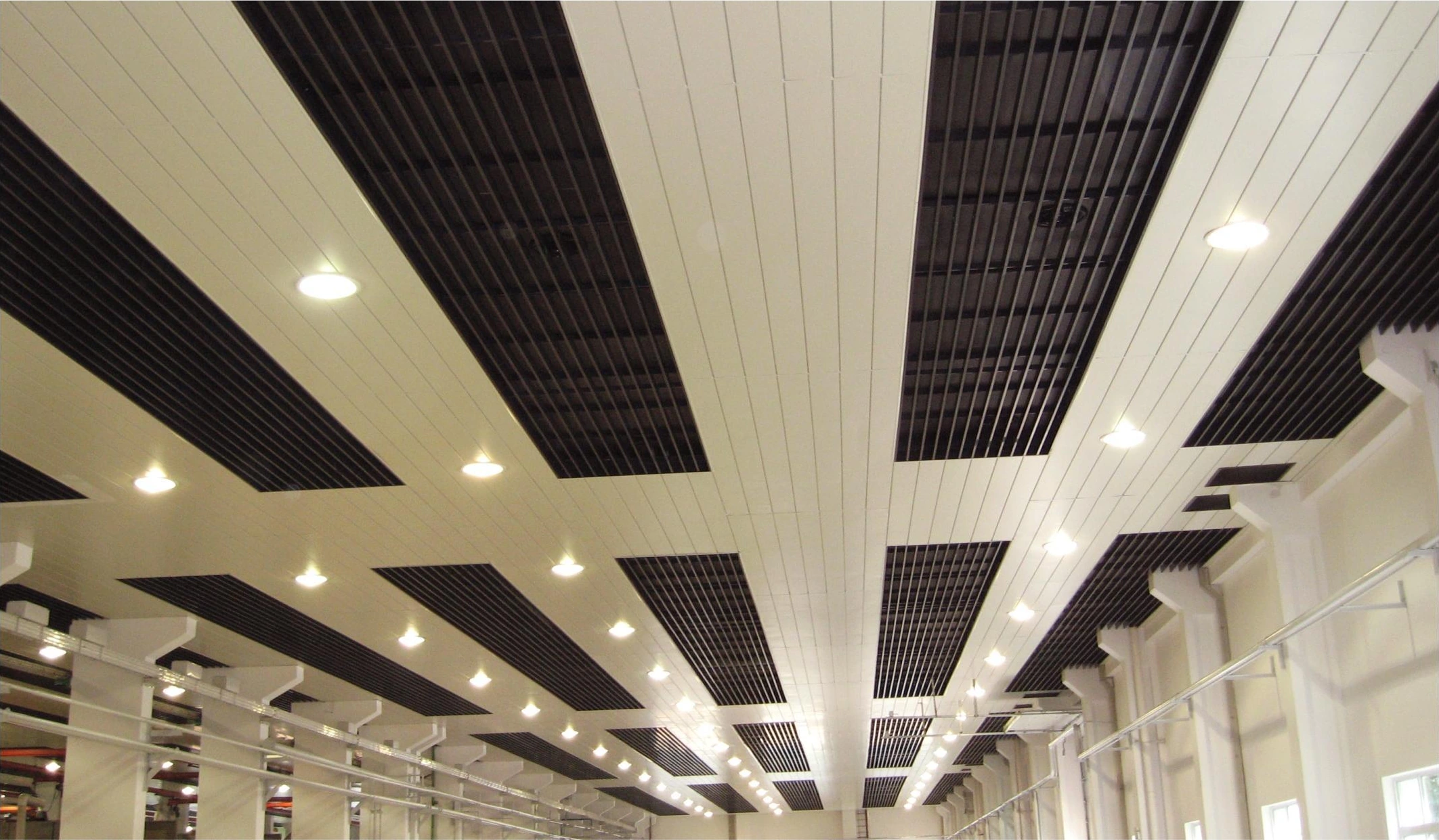 Parallel light ceiling strips alternating with dark open sections in a Wuxi facility
