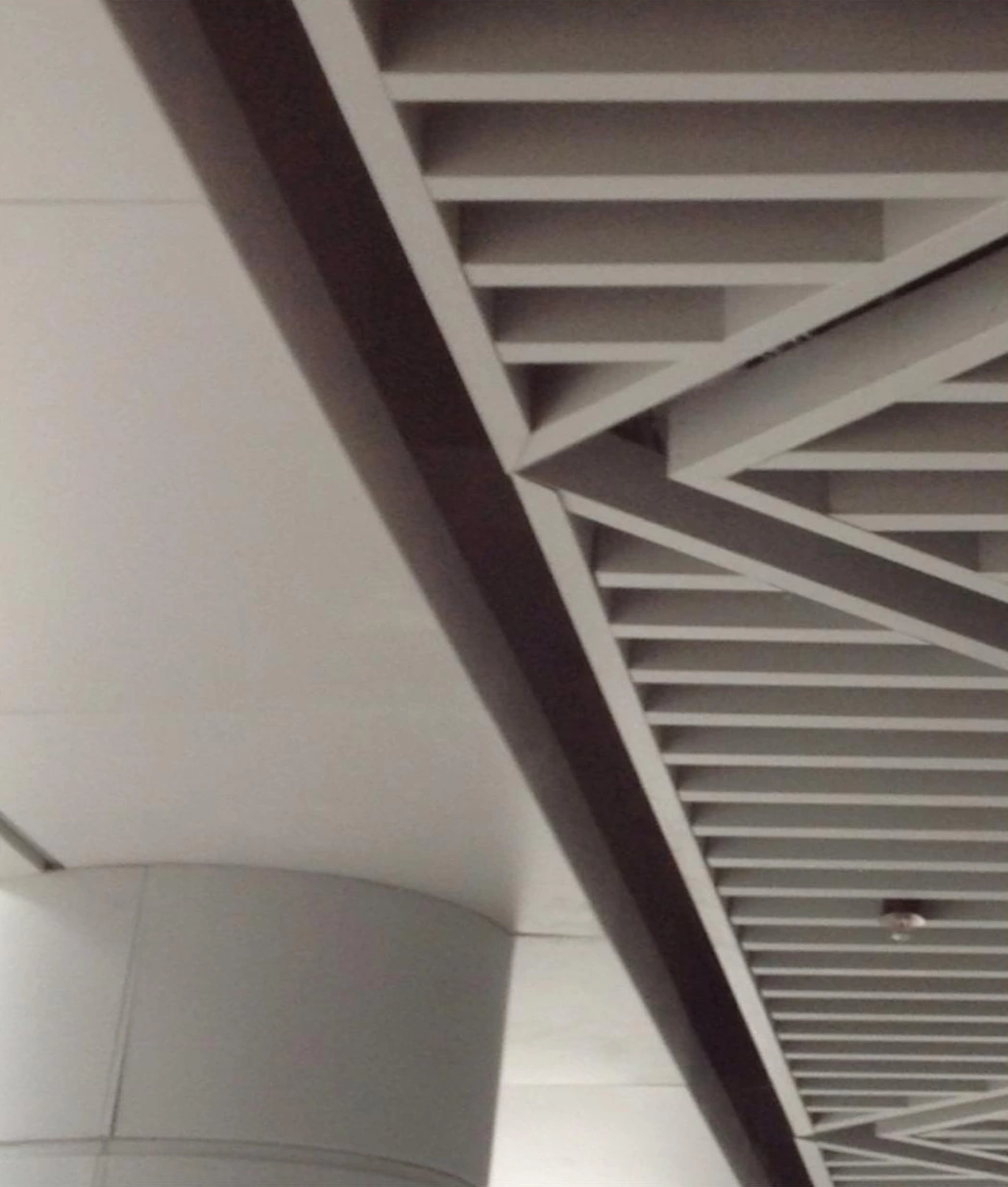 Angled ribbed soffit and cylindrical column at an office park entrance in Xuzhou