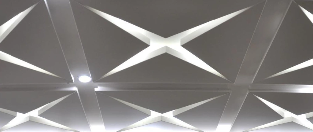 Faceted metal ceiling panels with intersecting folded edges and recessed lights in Zhongshan
